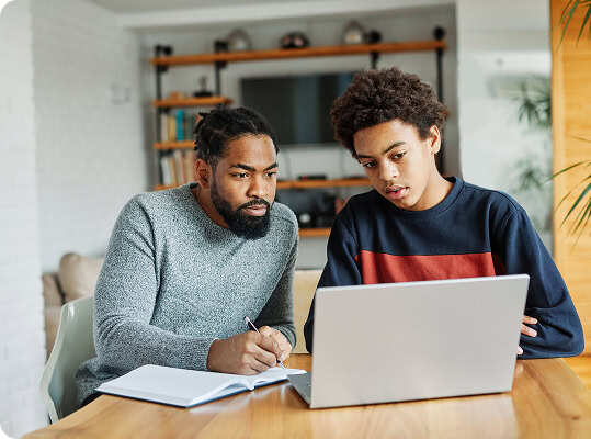 Man and son looking at a laptop together